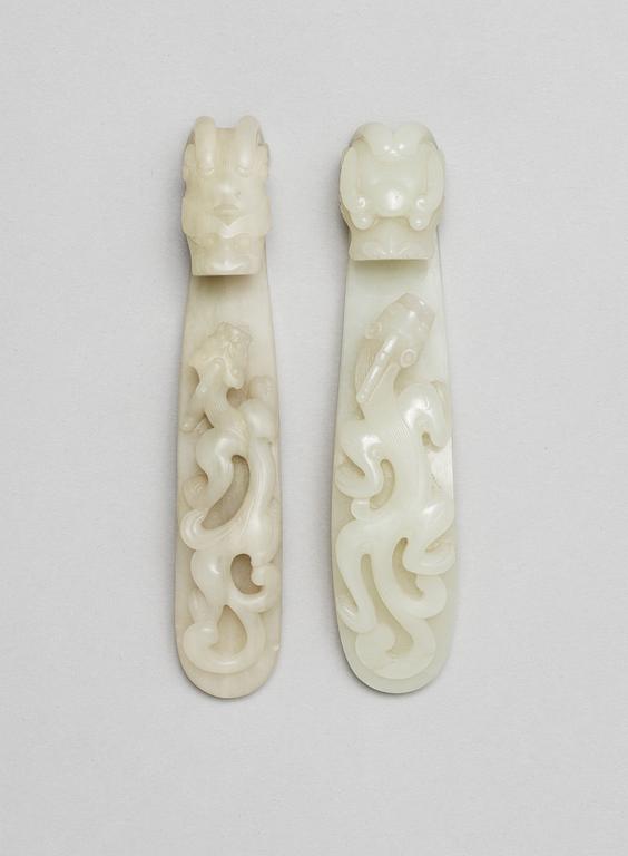 Two pale green garment hooks, Qing dynasty.