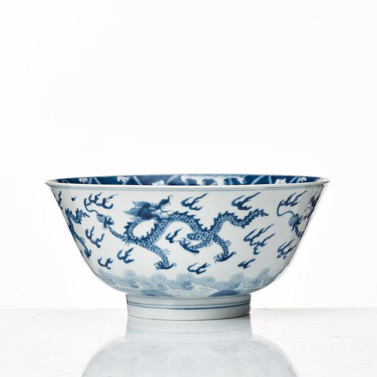 A blue and white four clawed dragon bowl, Qing dynasty, with Kangxis six character mark and period.