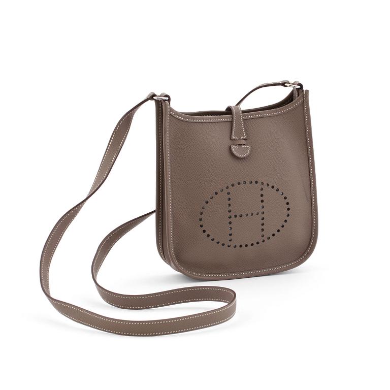 HERMÈS, a small veau epsom etoupe shoulderbag and card case, "Evelyne tpm".