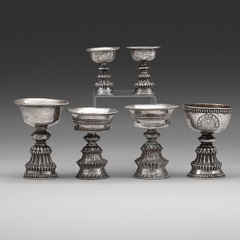 A group of six Tibetan silver/silvered Butter lamps, 19th Century.