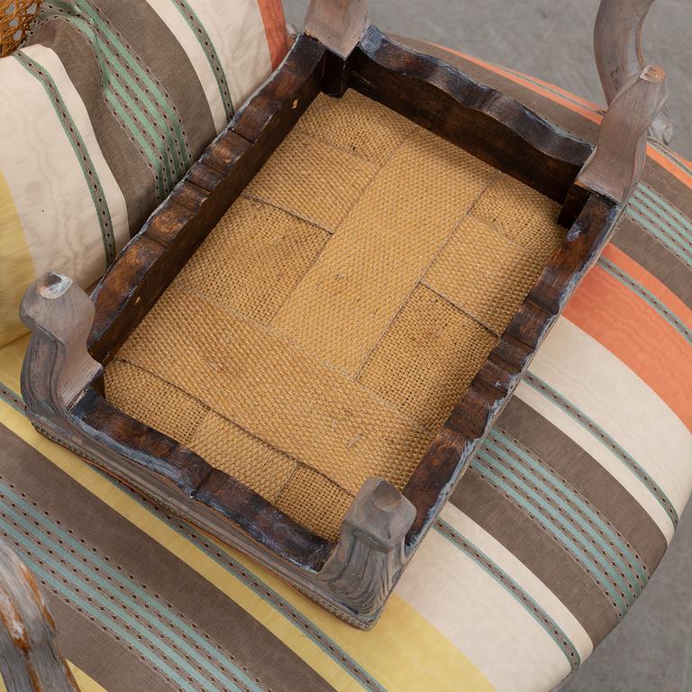 A later part of the 19th century rococo style armchair and second half of the 20th century stool.