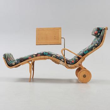 A Bruno Mathsson Swedish Modern chair with attached reading table, Karl Mathsson, Värnamo 1944.