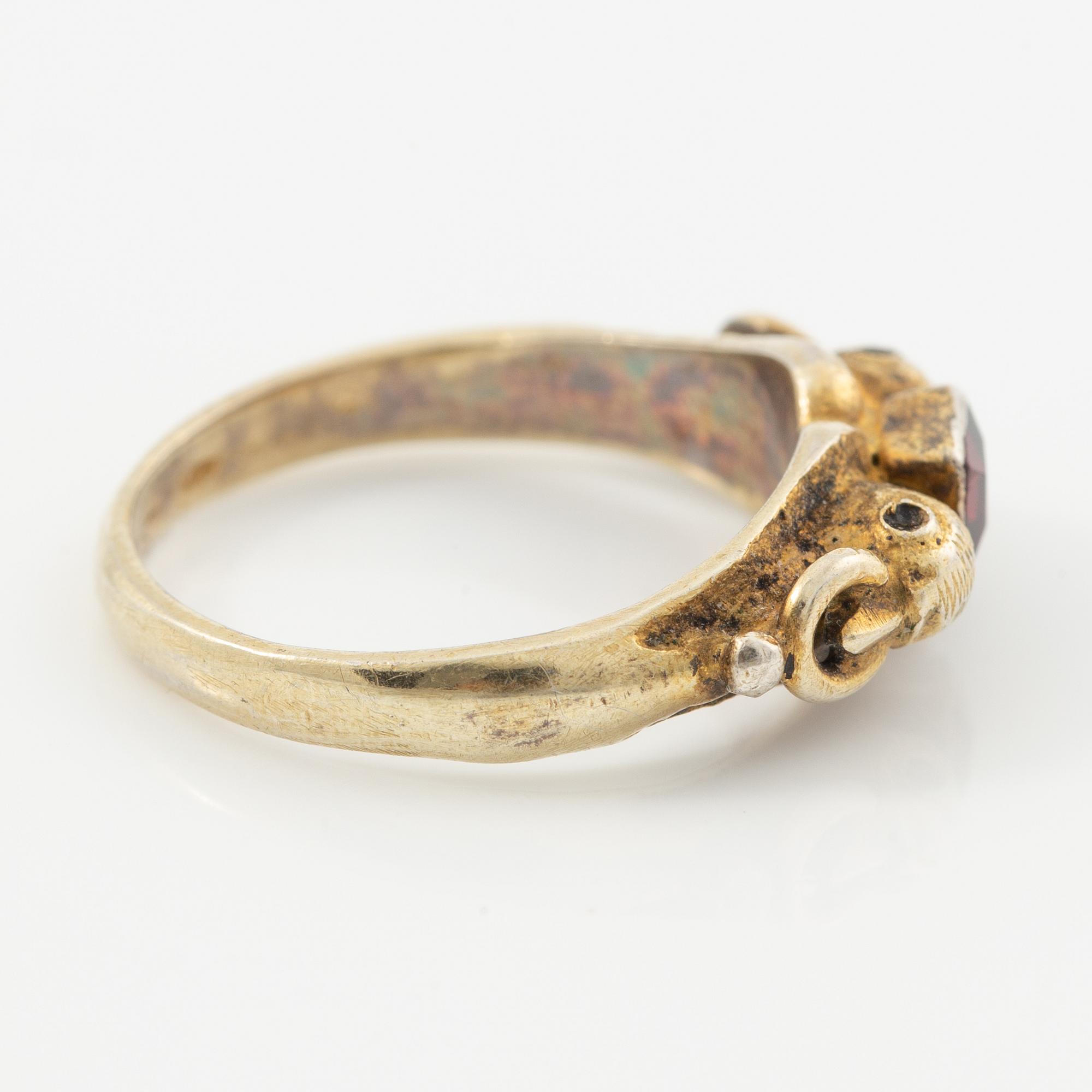Two rings in silver with pink/red stones.