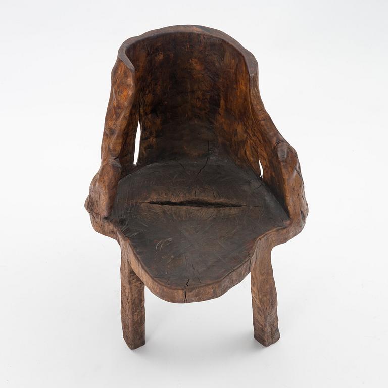 A one piece carved armchair, Sweden early 20th century.