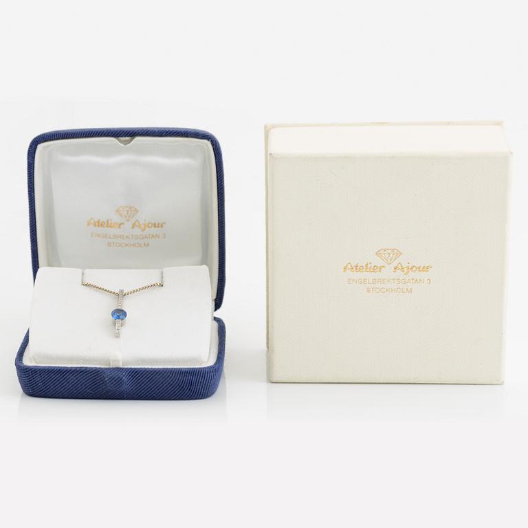 An 18K white gold necklace with a faceted sapphire.