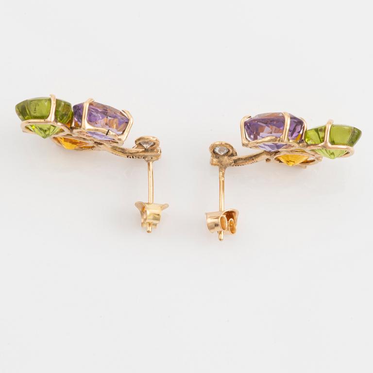 Earrings with yellow sapphires, cut flower-shaped peridot, amethyst, and brilliant-cut diamonds.