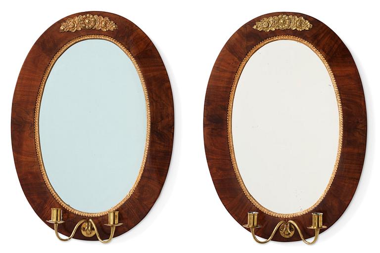 A pair of mahogany Empire two-light girandoles, early 19th century.