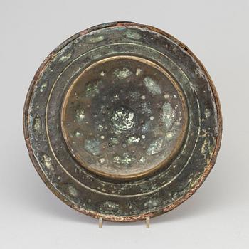 A Baroque brass repousse alms plate, Northern Europe 17th century.