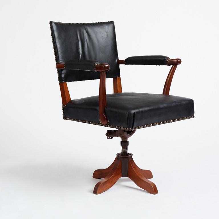 Josef Frank, a mahogany and black leather swivel chair, modified version of model 695, Svenskt Tenn, ca 1956-1957.