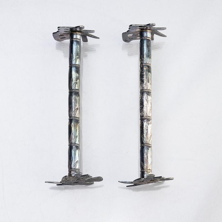 A silver bud vase, two stands for the butter knifve and a salt, China, early 20th Century.
