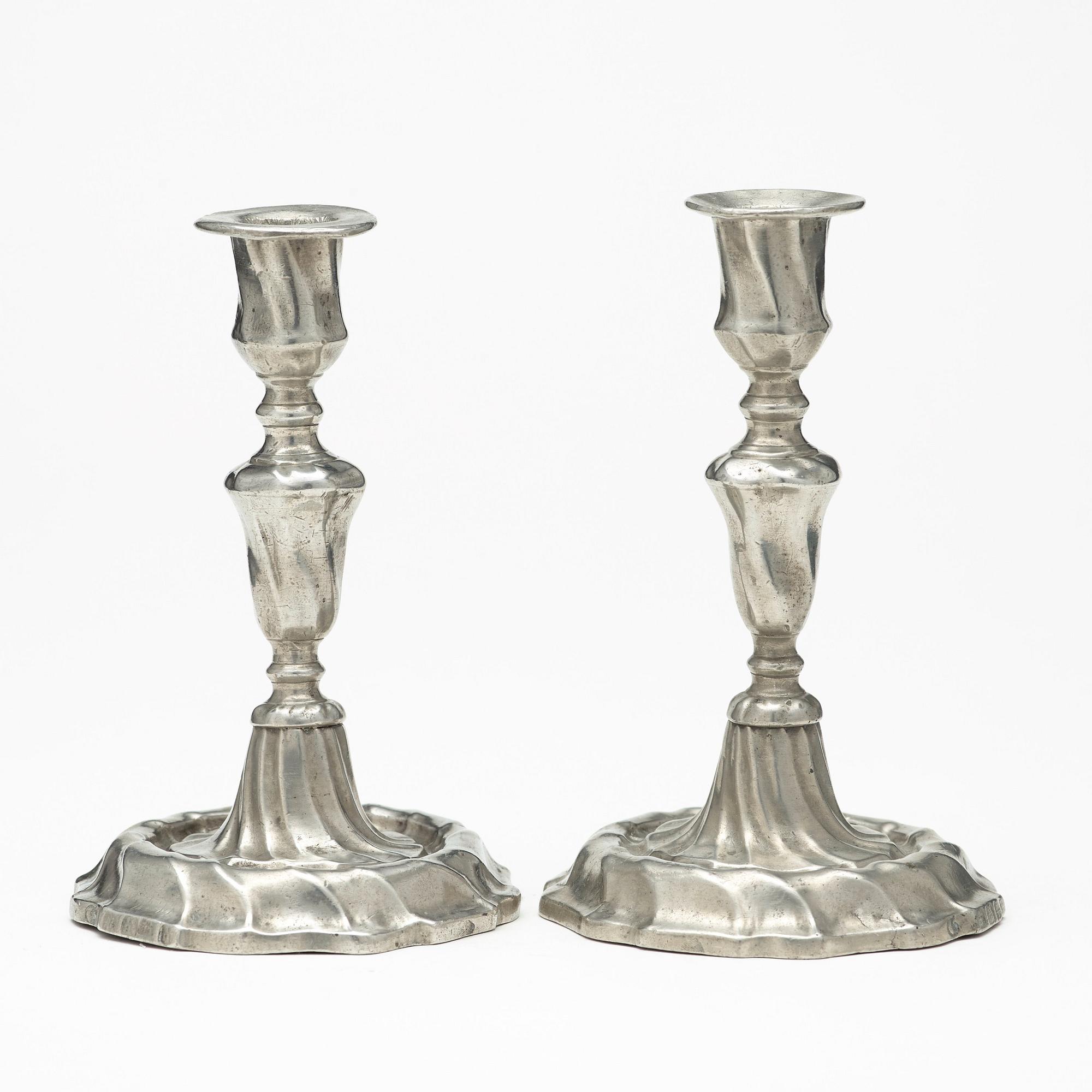 A pair of Swedish Rococo pewter candlesticks by L Lundwall 1762.