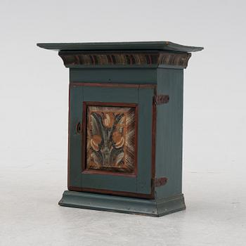 A painted wall cabinet.