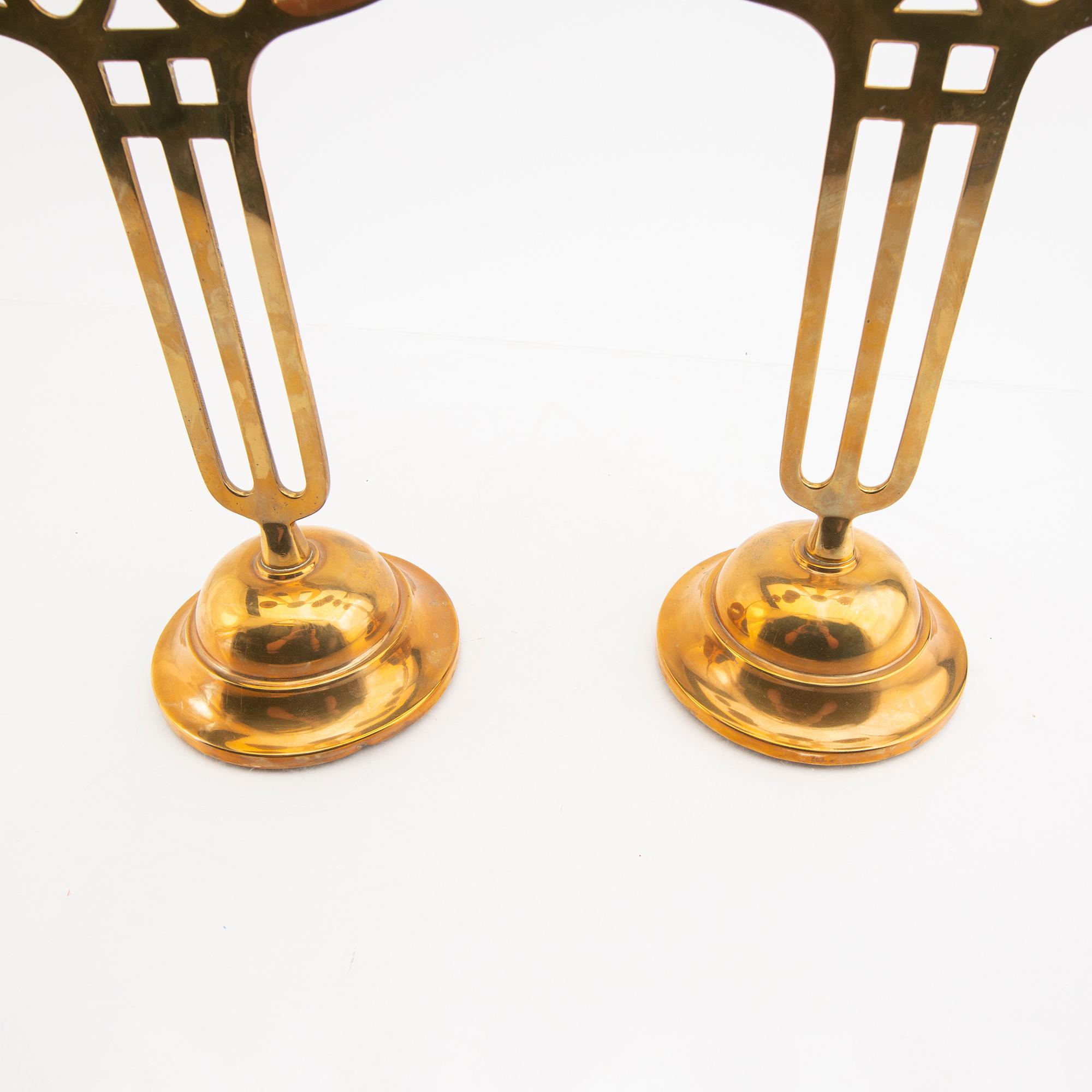 A öair of brass candelabras 20th century.