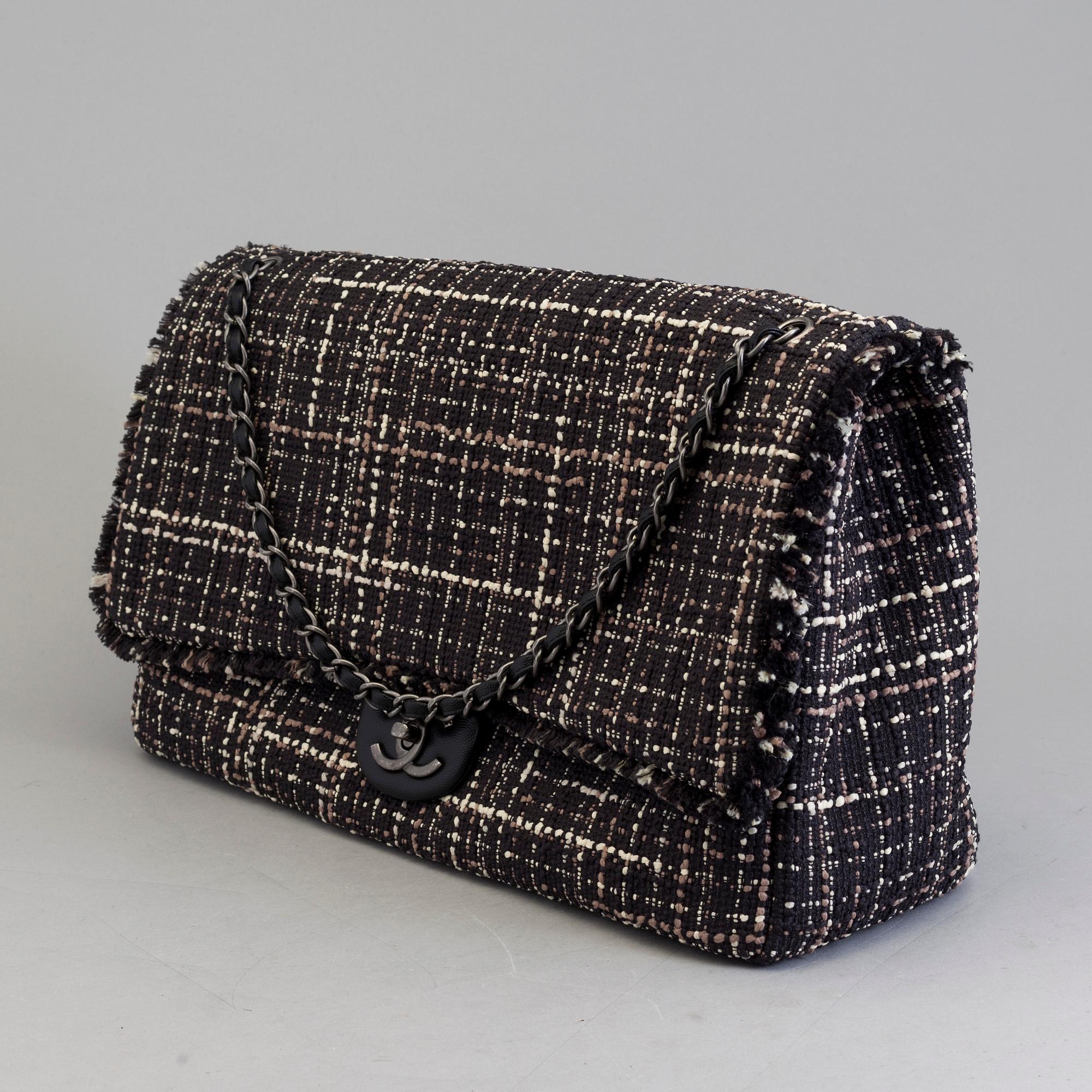 A tweed bag "Classic flip bag XL" by Chanel from 2016-2017.