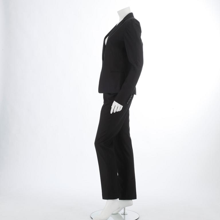 NOIR, a black wool and silk two-picee suit consisting of jacket and pants, size 42.