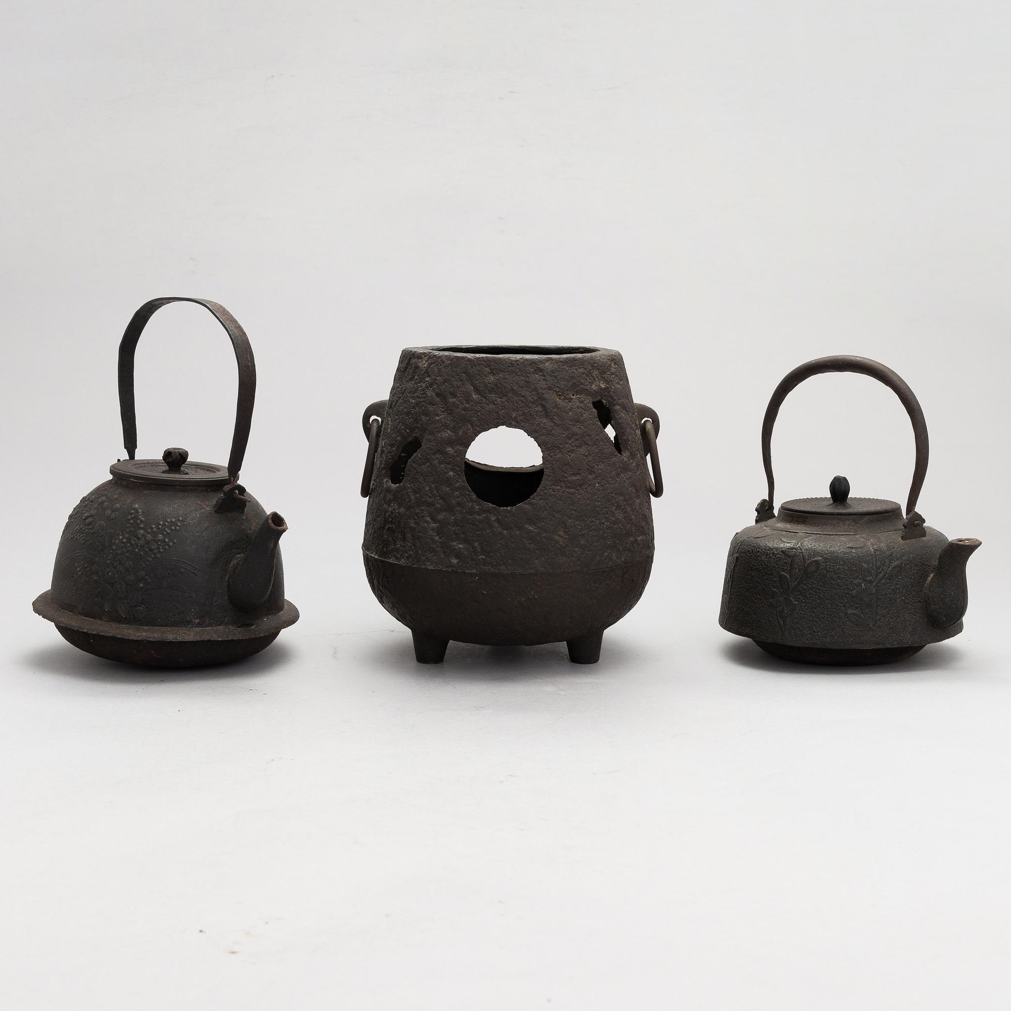 Two teapots and a hibachi brazier, Japan, early/ first half of the 20th century.