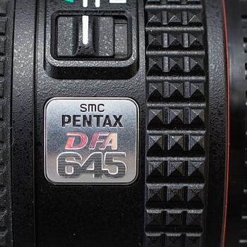 A black body medium format Pentax 645D camera with a SMC Pentax-D FA 645 55mm F2.8 AL [IF] SDM AW lens.