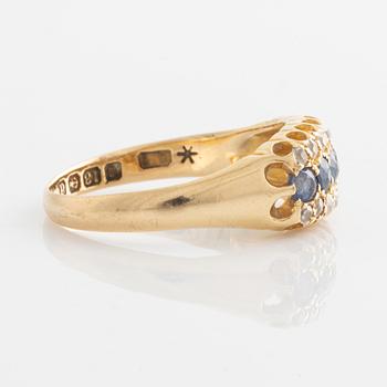 Ring in 18K gold with diamonds and blue stones.