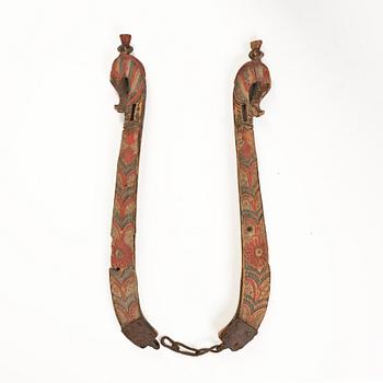 A pair of Swedish carved and painted horse harness parts, 18th century.