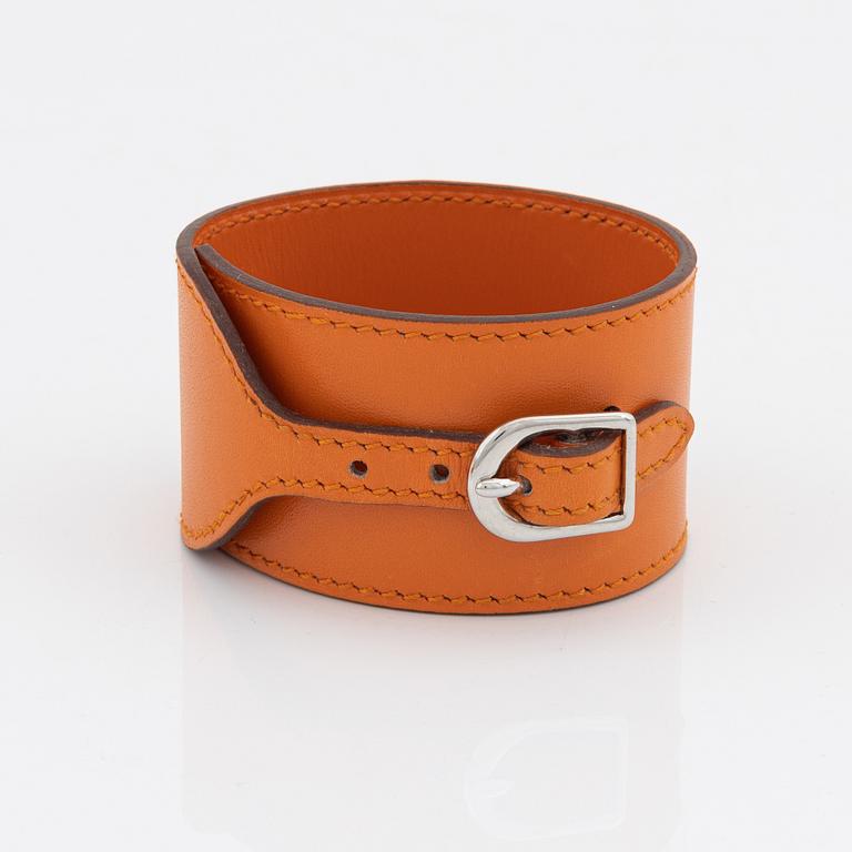 Hermès, A orange leather and palladium steel bracelet.