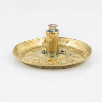 A repousse brass baroque candlestick, circa 1700.