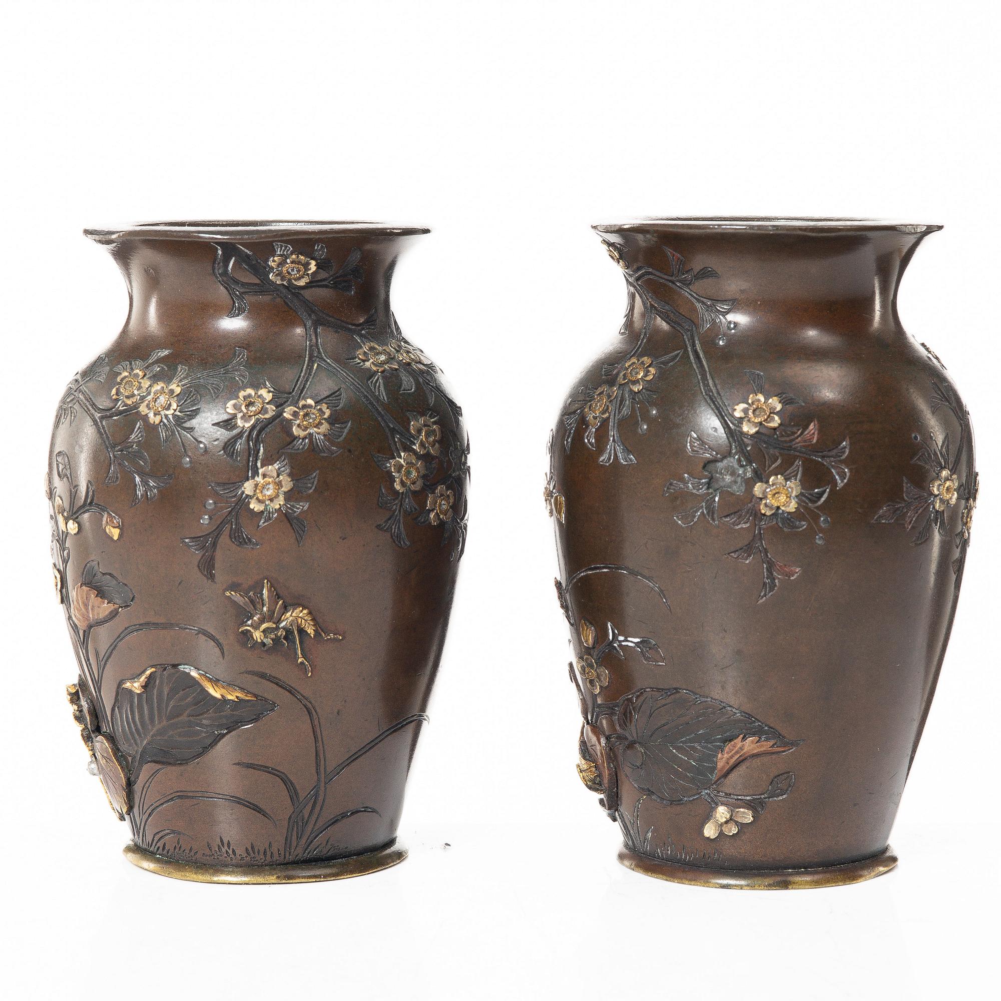 A pair of Japanese metal vases, Meiji (1868-1912).