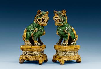 1285. A pair of green and yellow glazed dogs, late Ming dynasty (1368-1644). (2).