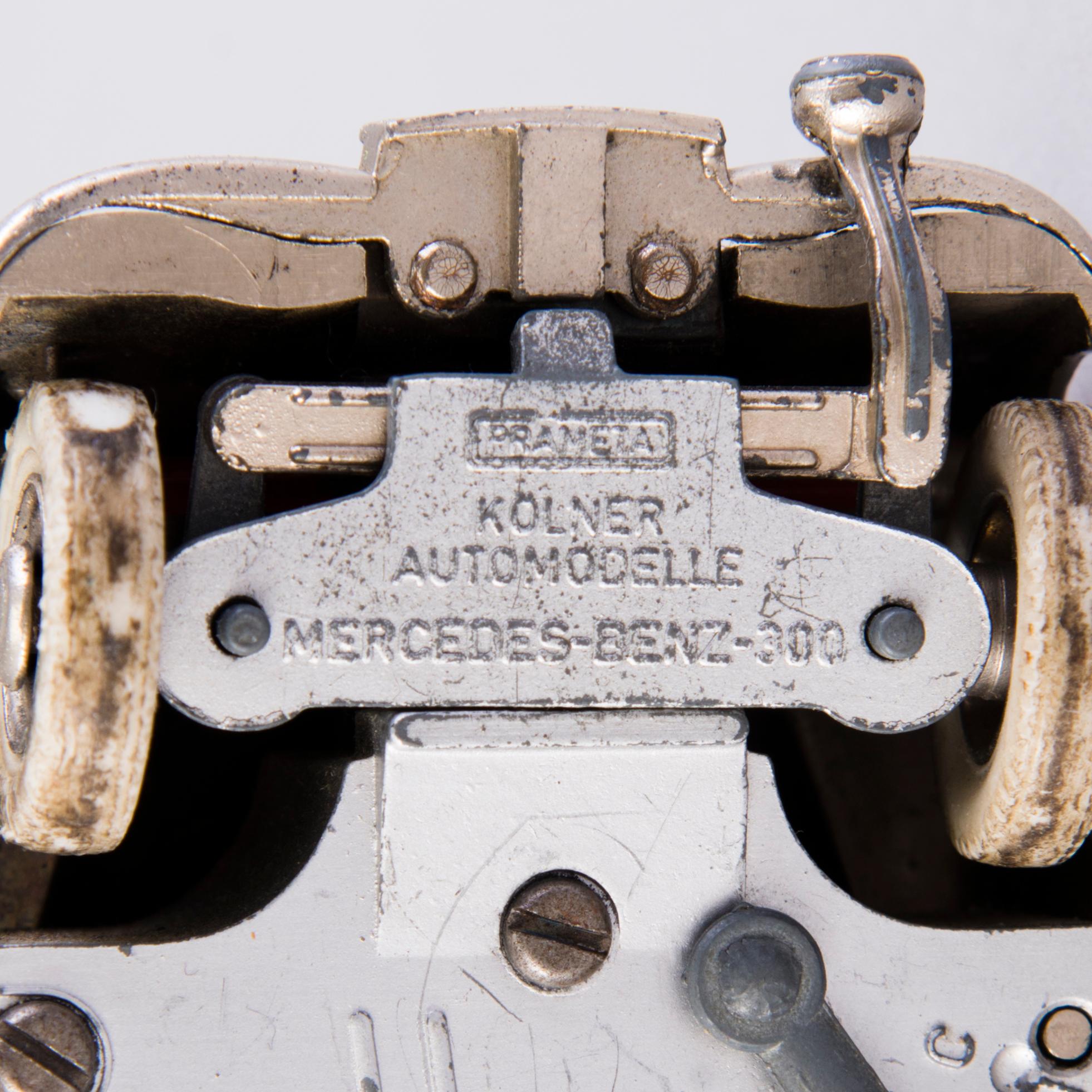 Two mid-20th century toy cars, chromed metal and wood.