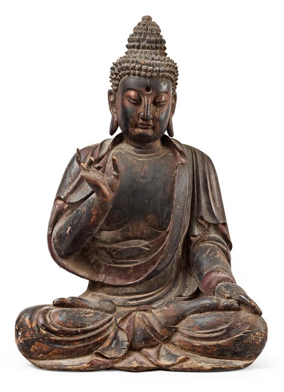 A Japanese partly lacquered wooden seated figure of Buddha, Edo (1603-1868).