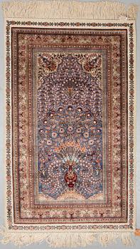 A chinese silk rug, ca 152,5 x 92,5 cm.
