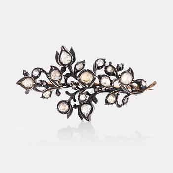 1056. A brooch set with rose-cut  diamonds.