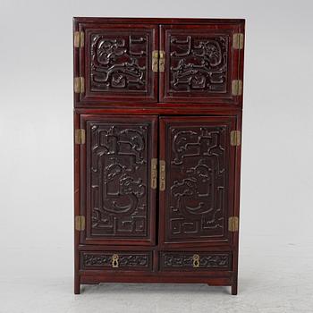 A small Chinese stained wood two part cabinet, 1900s.