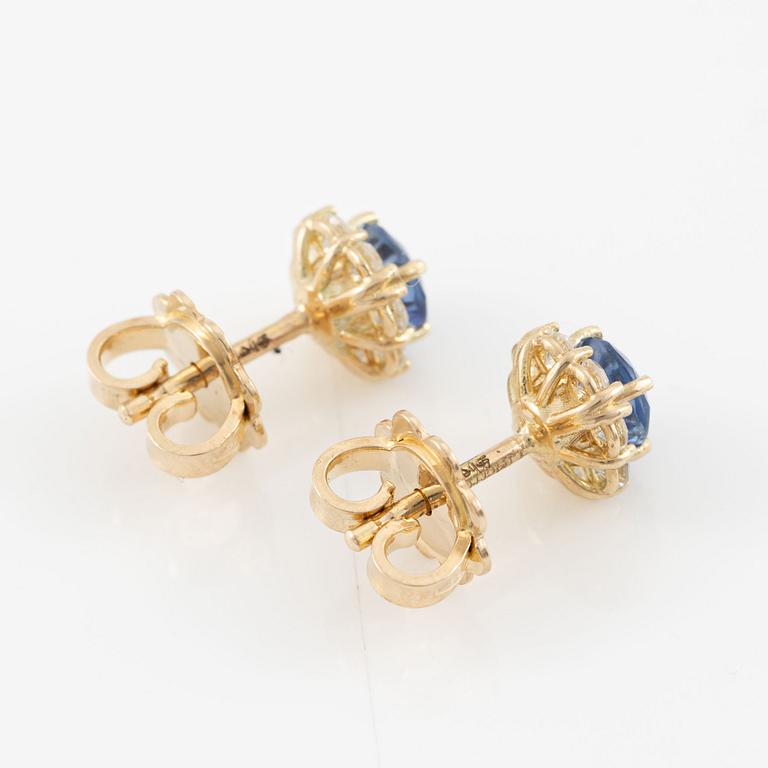 A pair of 14K gold earrings with faceted sapphires and octagon-cut diamonds.