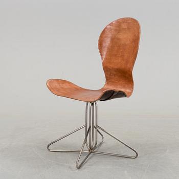 A contemporary iron easychair.