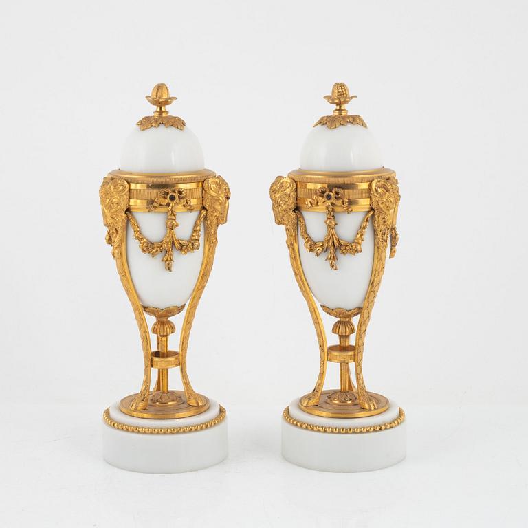 A pair of French Louis XVI-style ormolu and marble cassolettes, later part of the 19th century.