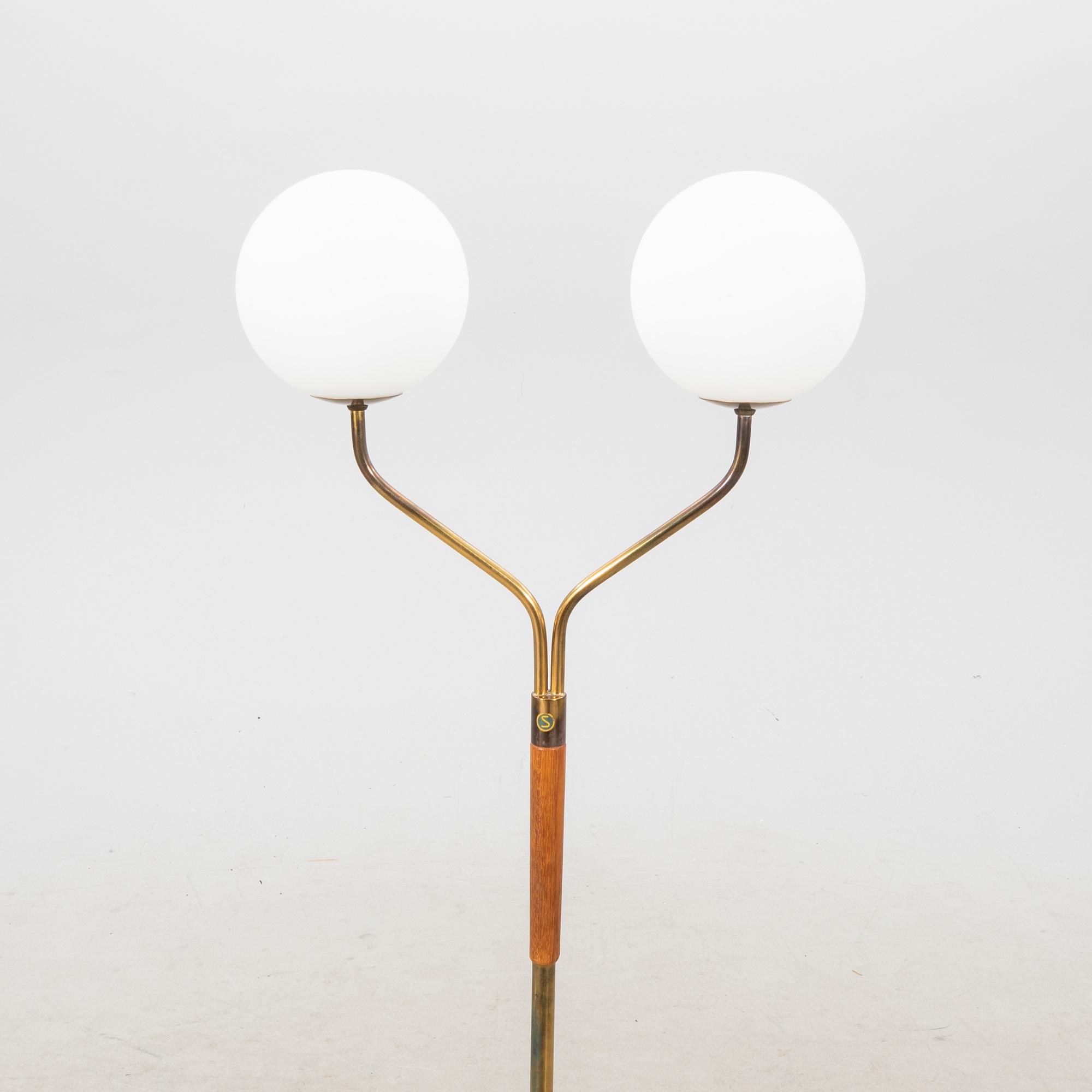 A mid 20th century teak and brass floor lamp.