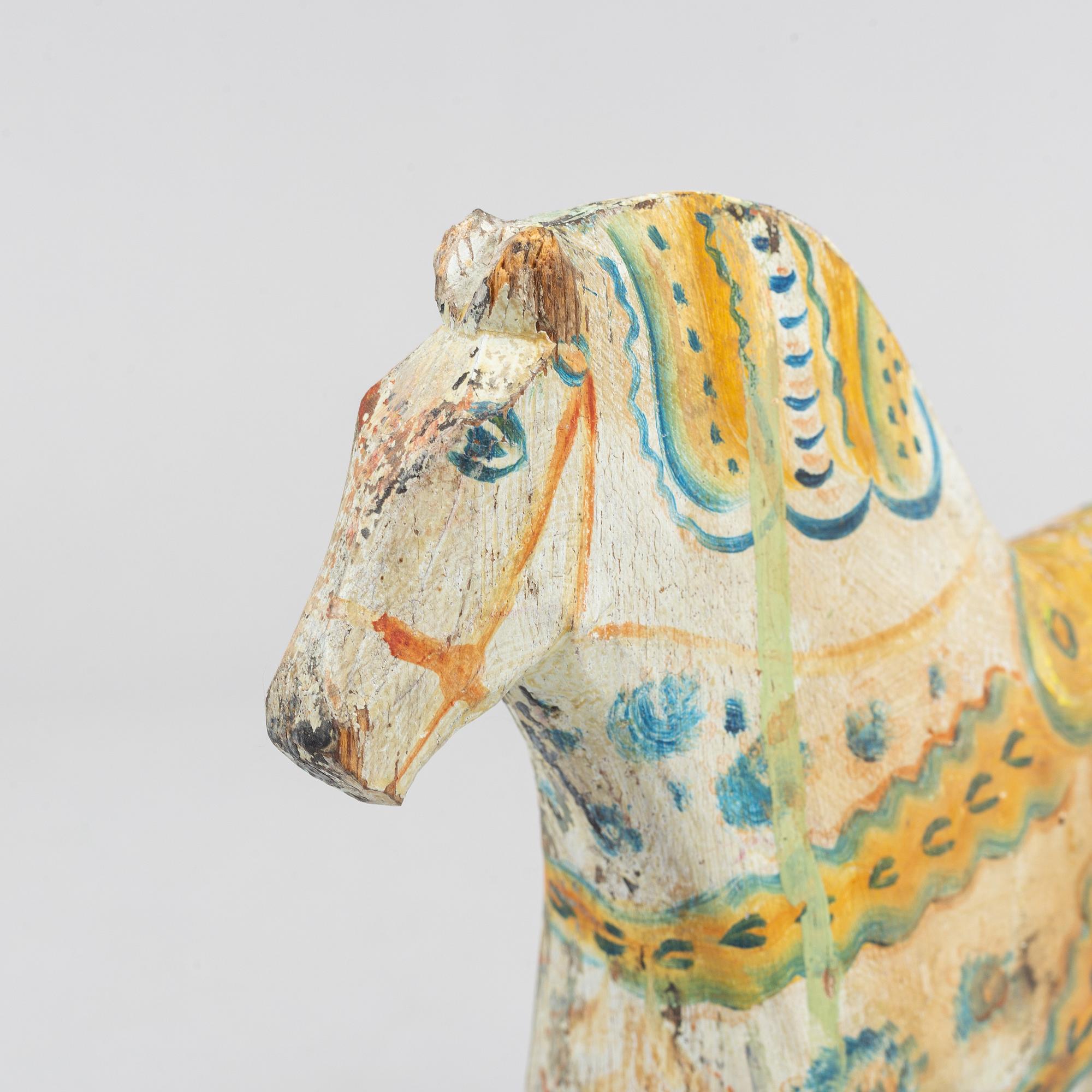 A painted Swedish wooden horse from the first half of the 20th century.