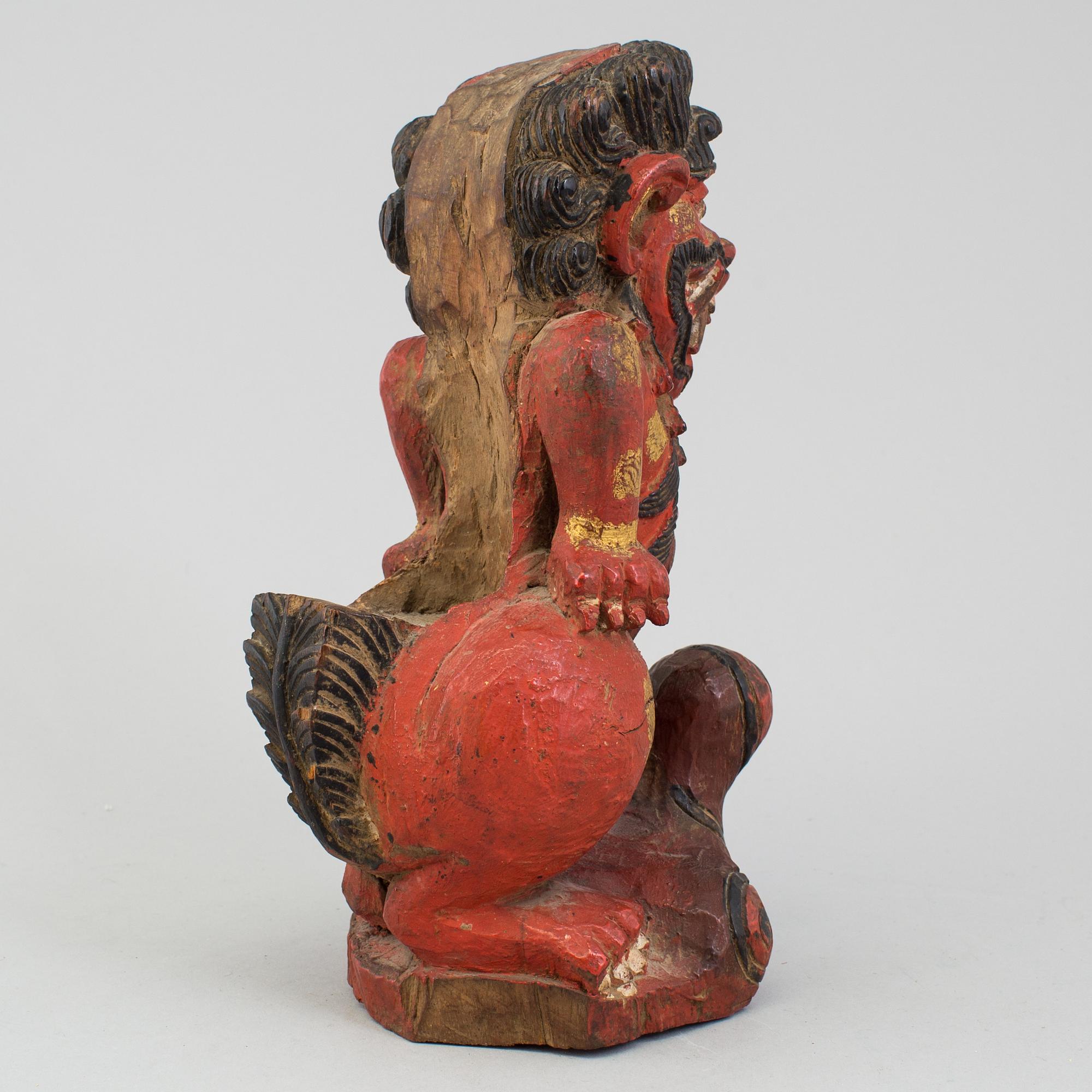 A wooden sculpture of a deity, India, circa 1900.