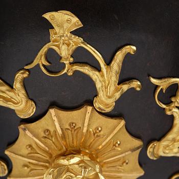 A patinated and ormolu six-light Empire chandelier, Stockholm, first part 19th century.