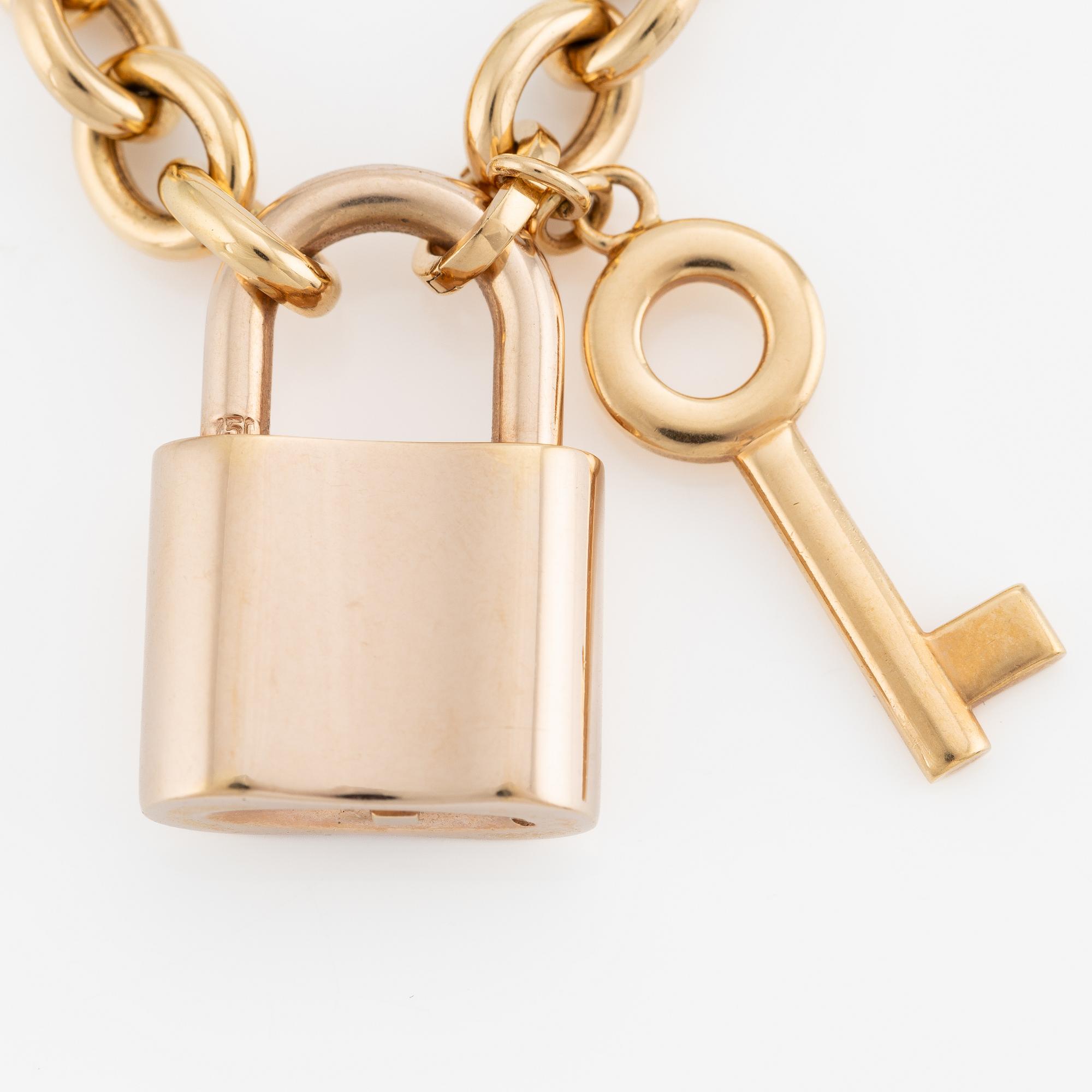 Collier, 18K guld, Gübelin, med 
berlock/hänge i form av lås Gübelin med briljantslipade diamanter.