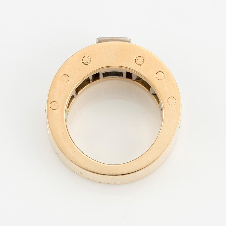 An 18K gold Gaudy ring with a princess-cut diamond.