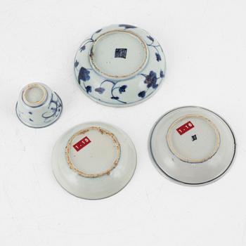 A blue and white cup and three dishes, Ming dynasty (1368-1644).