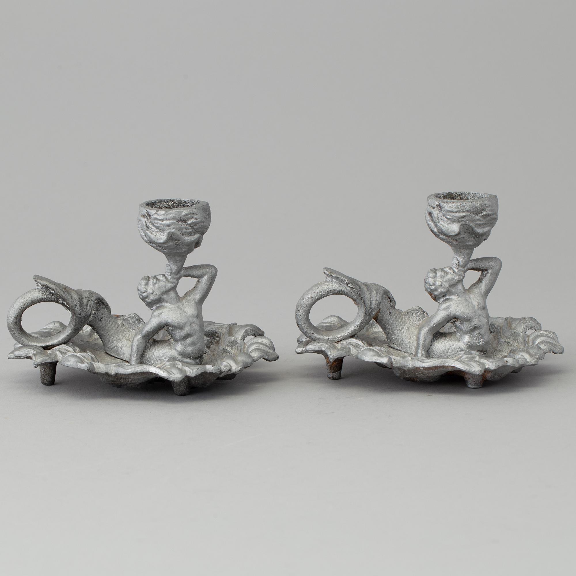 A pair of cast iron candlesticks, marked Verlag bei, A. Meves, Berlin, late 20th century.