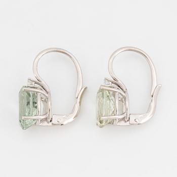 Light-green tourmaline and brilliant-cut diamond earrings.