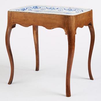 A rococo faience-top tea table, Rörstrand 1760.