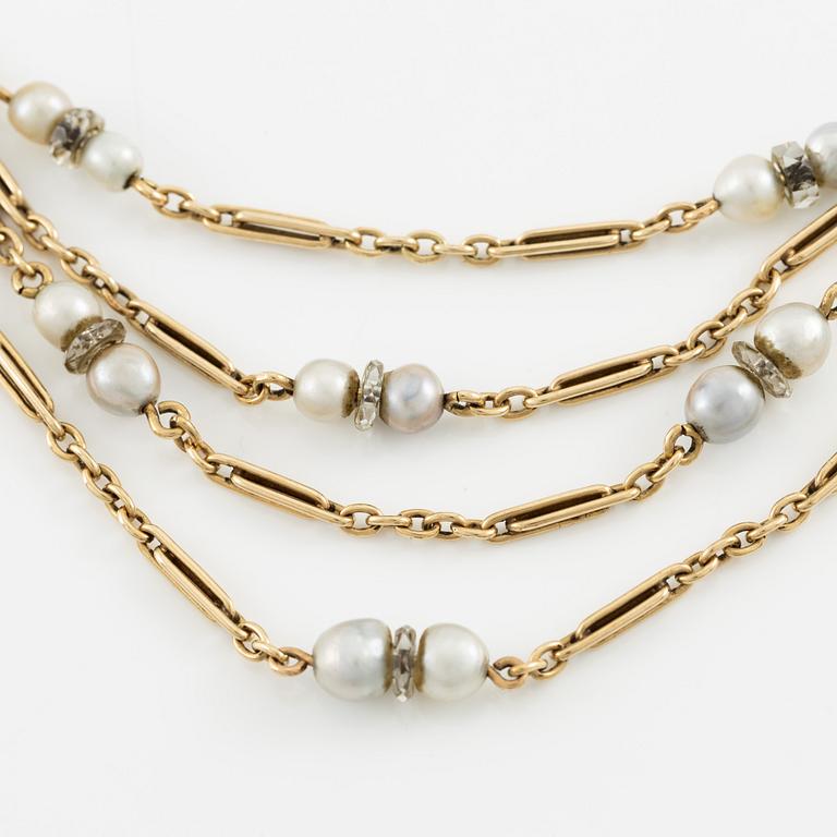 A W.A. Bolin necklace in 18K gold with pearls and white discs.