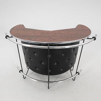 A 1970s bar and four stools.