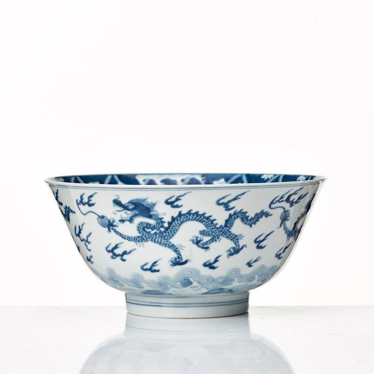 A blue and white four clawed dragon bowl, Qing dynasty, with Kangxis six character mark and period.