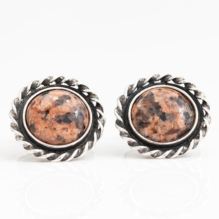 A set of three pairs of silver cufflinks with hematite, tigers eye and granite. Turun Hopea and Osvald Mättö.