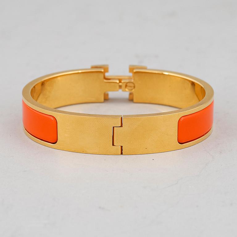 HERMÈS, a 'Clic H' bangle.